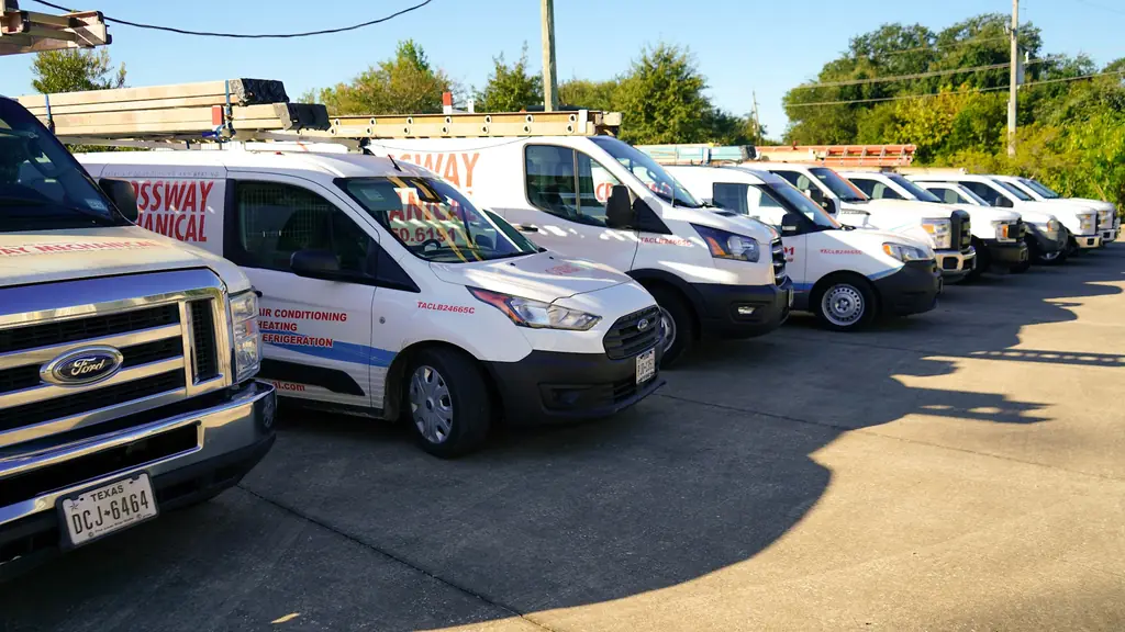 Row of white Crossway Mechanical vans on the Tomball yard, license TACLB24665C lettered on the side