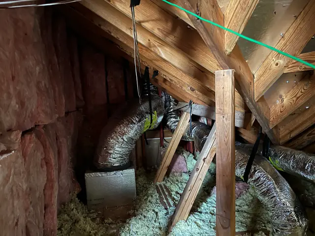 Flex duct running across blown attic insulation