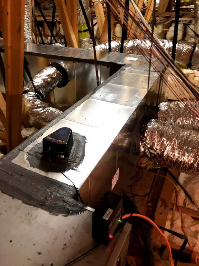 REME HALO air purifier installed in an attic supply plenum, seams sealed with mastic